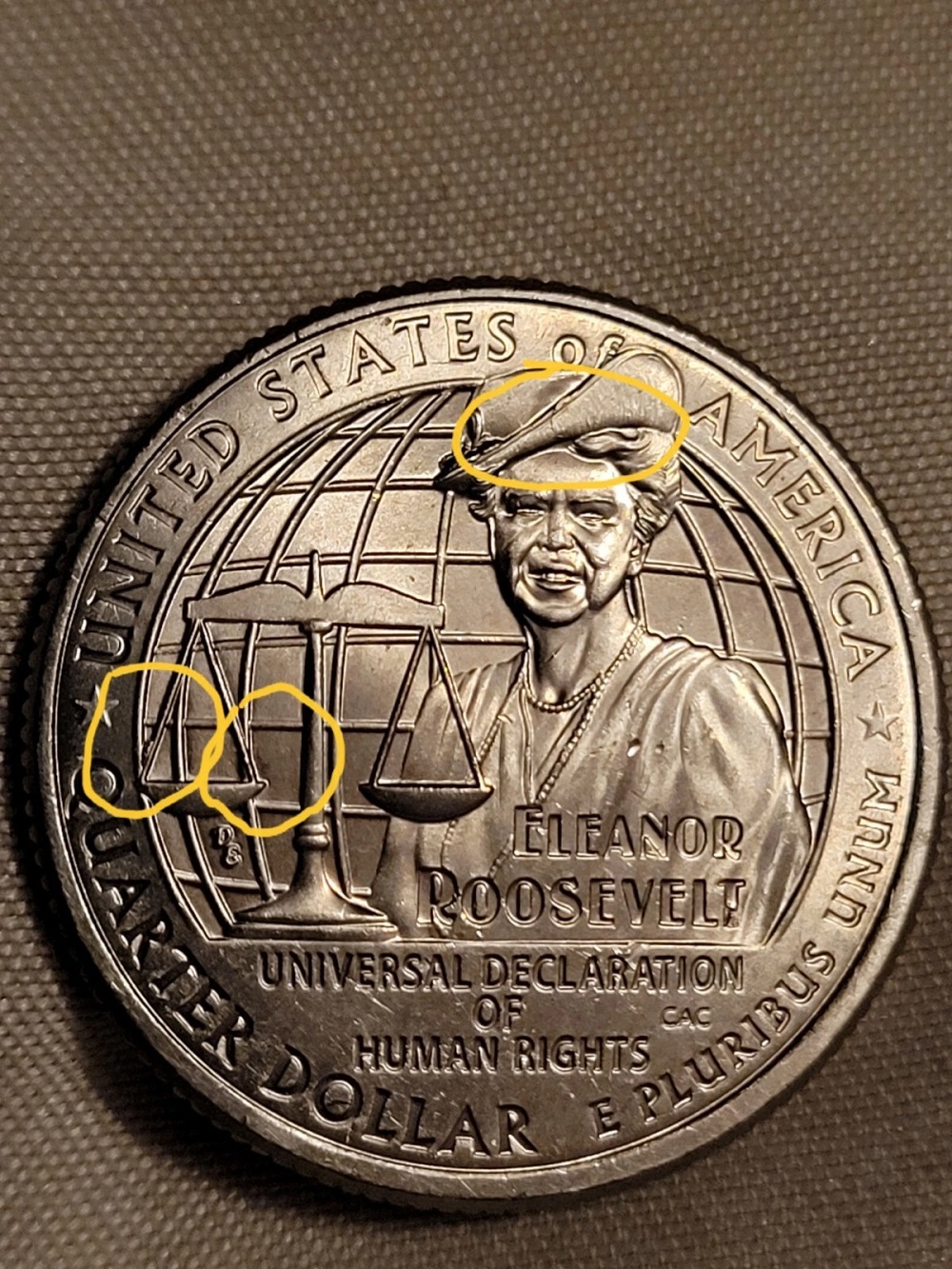 2023 Eleanor Roosevelt quarter showing retained cud die break at the upper rim area, raised irregular metal connected to rim